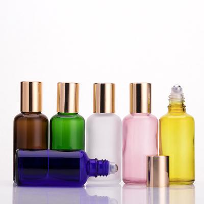 China Recycled Material 30ml 50ml 100ml Colored Essential Oil Rollerball Frosted Glass Bottle With Gold Cap for sale