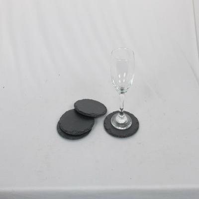 China Sustainable Natural Black Stone Slate Coasters Set Of 4 Round Rough Chipped Edges for sale