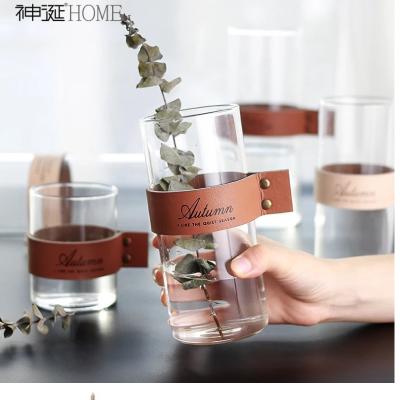 China Nordic Contracted Glass Home Decoration Hanging Art Flower Plant Holder Modern Plant Hanger Leather Strap Flower Vase for sale