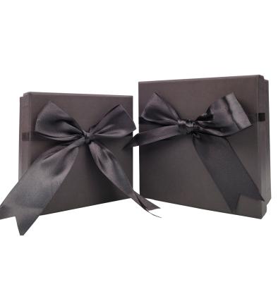 China Customized Recyclable Stock Logo Luxury Cardboard Magnetic Folding Gift Box With Bow for sale