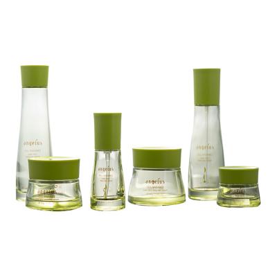 China Newest design good quality custom green glass cream jar pump bottle cosmetic set cosmetic set bottle for lotion for sale