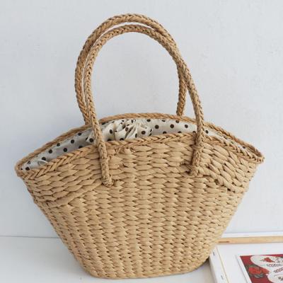 China Wholesale Durable Natural Handmade Woven Beach Straw Vegetable Plankton Storage Bag Basket With Pompom for sale