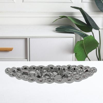 China Sustainable Boat Ceramic Fruit Shape Candy Dish Handmade Porcelain Tray With Cutout Holes for sale