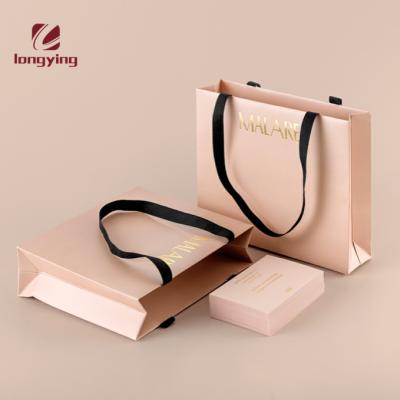 China Fashion Recyclable Custom Luxury Paper Bag With Clothes Tag Hot Stamping Foils For Mens Suit Girls Dresses Uniforms Clothing Paper Bag for sale