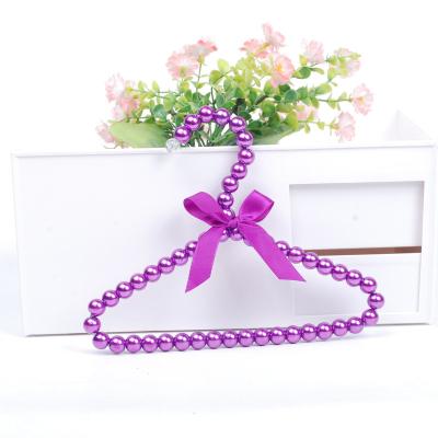 China Amazon Sustainable Hot Sale Pet Clothes Plastic Hanger With Bowknot Bead Hanger Pet Clothes Hanger for sale