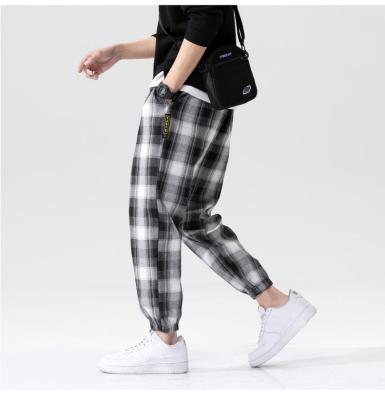 China Black and white men's plaid anti-pilling pants ice silk pants summer drape nine dots summer slim casual pants for sale