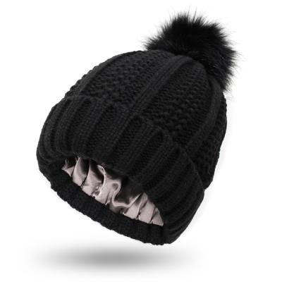 China Winter COMMON Fashion Smooth Satin Striping Pom Pom Beanie Cable Knitted Hats for sale