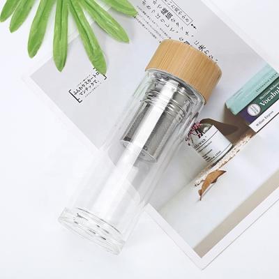 China Eco Sustainable Bamboo Lid 750ml Insulated Double Wall Glass Water Bottle With Stainless Steel Tea Infuser for sale