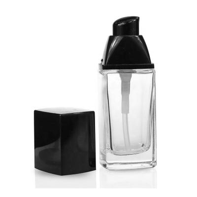 China High End Square 30ml Cosmetic Glass Bottles Eco - Friendly With Pump Cap For Cosmetic Essence Lotion In Stock for sale