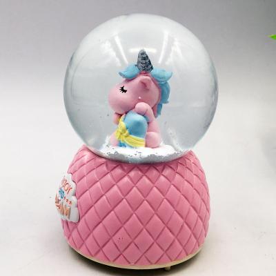 China Europe Best Selling Customized Unicorn Snow Light Music Resin 100mm Christmas Decorating Ball for sale