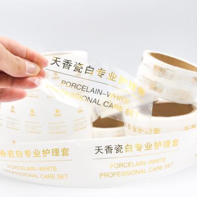 China Customized Printing Clear Stickers Waterproof Self Adhesive Logo Transparent Gold Foil Label for sale