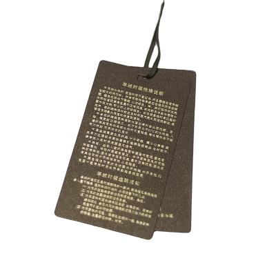 China Other Exquisite Hollow Out Hang Tags Custom Brand Garment Tags And Clothing Price Labels for sale