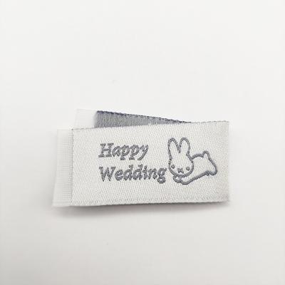 China Viable Custom Design Bunny Pattern Horizontal Fold Woven Label Clothing Label Wholesale Garment Labels for sale