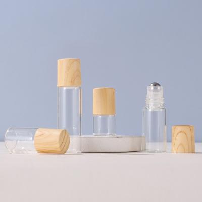 China 1ml 2ml 3ml 5ml Cosmetic Portable Refillable Clear Perfume Sample Essential Oil Roll On Roller Bottle With Wood Grain Plastic Lid for sale