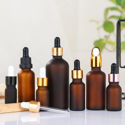 China Luxury Liquor Bottles Wholesale Empty Hair Oil Bottles Matte 50ml 10ml 30ml 15ml Gold Black Caps Frosted Amber Glass Dropper Essential Oil Bottle for sale