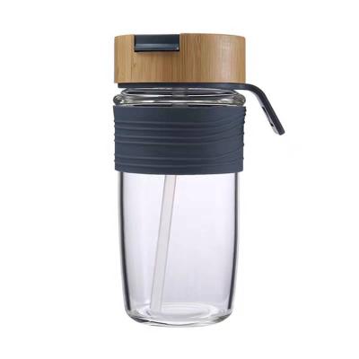 China Minimalist Custom Logo Silicone Sleeve 500ml Clear Container With Metal Bamboo Lid Drinking Borosilicate Glass Frosted Water Bottle 1000ml for sale