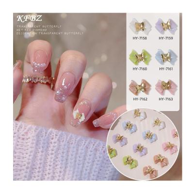 China Nail Art Decoration 10pcs/bag Bowknot Designers Nail Charms Bow Texture Painted White Metal Gold Butterfly Nail Charms for sale