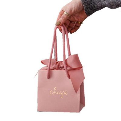 China Recyclable Factory direct customized hot stamped small jewelry paper items packaging bags with pink cotton handle for sale