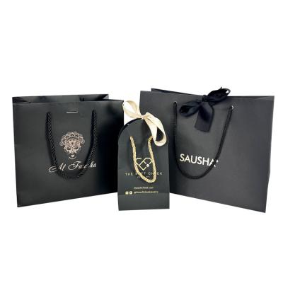 China Recyclable Customized printed  golden hot stamping all black paper bags for luxury jewelry items or cosmetics packaging with personal name for sale