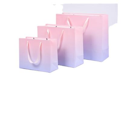 China Design Gift New Year Party Shop Packing Popular Paper Bag With Ribbon for sale