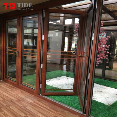 China Heat Insulation Soundproof Aluminum Clad Wooden Folding Doors With Double Glass for sale