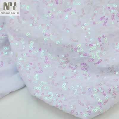 China Nanyee Breathable Textile 3mm Mini Earthworn Squiggle Sequin On White Stretch Knit Fabric for sale