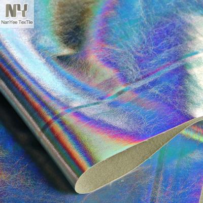 China Nanyee Waterproof Textile 0.6mm Bonded Nonwoven Rainbow Foiled PU Fabric for sale