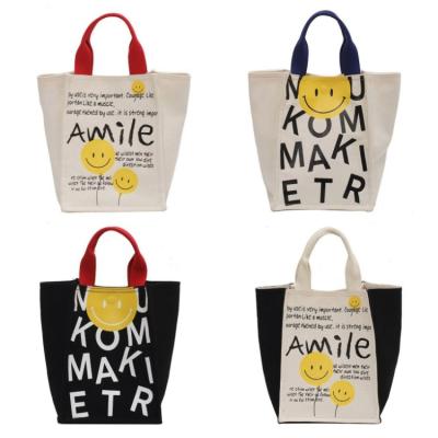 China Custom cute rope handle cartoon smile canvas tote shopping bag logo men ladies student handbags for sale