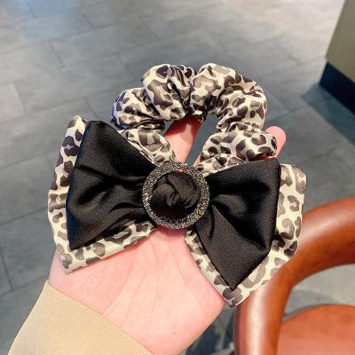 China Korean hair scrunchies new fashion version girl hair jewelry leopard print bow tie ponytail hair rope for sale