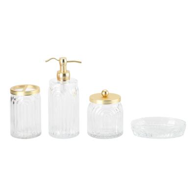 China Glass Bathroom Accessories Clear Ribbed Vertical Stripe Luxury Lotion Bottle With Gold Pump for sale