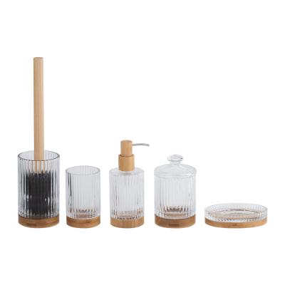 China Glass bathroom countertop accessories clear with round shape and ribbed vertical stripe and wood base toothbrush tumbler soap dish cotton jar for sale