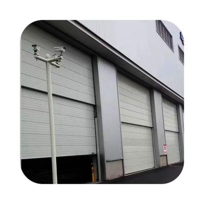 China Windproof Industrial Vertical Lifting Sectional Sliding Door for sale