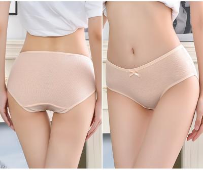 China Cheap panties solid color mid waist panties decorated with antibacterial knot hip girly panties package for sale