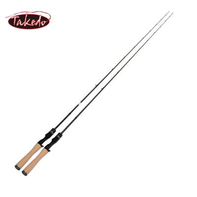 China TAKEDO High Density Carbon Fishing Rod Sea Bass Telescopic Spinning Casting Rod With Wooden Reel Seat for sale