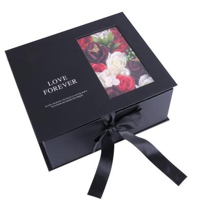 Cina High Quality Valentine's christmas flower rigid black paper bag set gift box packaging with clear window in vendita