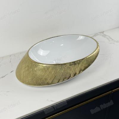 China Modern Sanitary ware bathroom decoration high end ceramic art basin golden color counter top face wash basin for sale