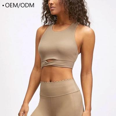 China Breathable Custom Crop Women Yoga Crop Top Solid Colors Comfy Twist Logo Sports Bra for sale