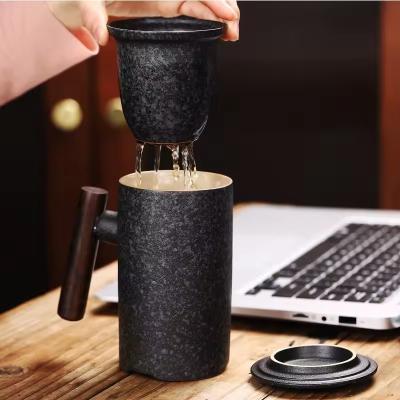 China Ceramic Wooden Handle Mug Tea Water Separation Cup Tea Cup Personalized Lettering for sale