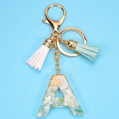 China OEM 26 Letter Resin Ladies Gold Foil Bag Ornament Key Chain Tassel Bag Accessories Pendant Key Chain for sale