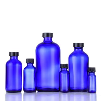 China Cosmetic 16 oz Blue Round Boston Glass Bottles Empty 4 oz Boston Bottles With Black Poly Cone Cap For Essential Oil , Perfume for sale