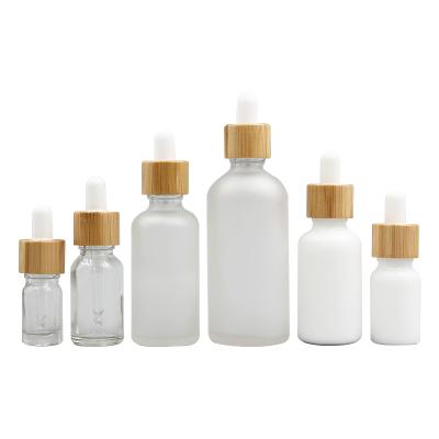 China Luxury Essential Oil Cosmetic Glass Bottle 5ml 50ml 100ml Dropper Bottle 30ml Serum Bottle Dropper With Bamboo Lids for sale