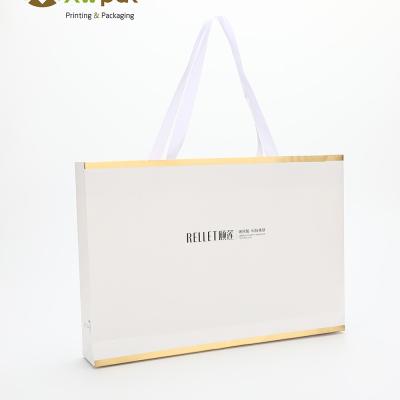 China Wholesale custom printed white luxury shopping gift paper bag with handle for sale