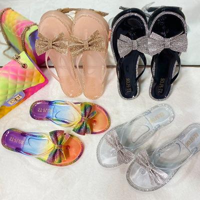 China Cute Women Jelly Sandals Rainbow Rhinestone Slides Waterproof Summer Bowknot Floats Jelly Flip Flops Slippers for sale