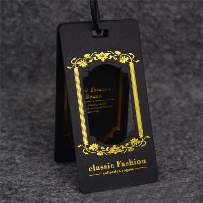 China Swing Sustainable Coated Paper Tag With Gold Stamping Printing Logo For Clothes With String for sale