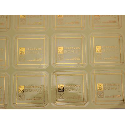 China OEM Waterproof Self Adhesive Gold Stamping Logo Label , Plastic Gold Foil Logo Roll Label Sticker for sale