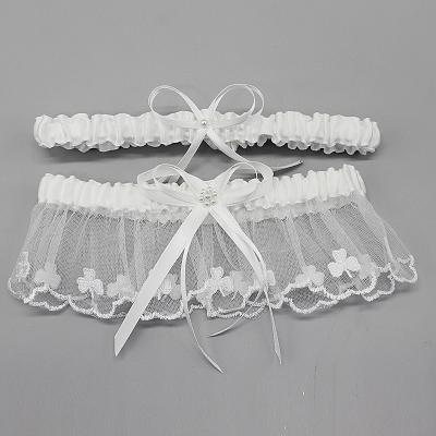 China M8547 slim line garter is a simple ivory satin band accented with a small flower blossom with sparkling center. 34-66cm for sale