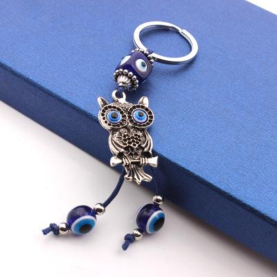 China 2021 Promotion Gift Turkey Blue Eye Beads Alloy Braided Owl Pearl Key Chain Bag Pendant Square for sale