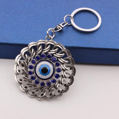 China Promotion Gift Round Alloy Hollow Flower With Key Chain Blue Pendant Bag Evil Eye Christmas Gift for sale