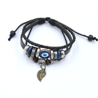 China Ethnic Style Antique Bronze Hollow Leaf Pendant With Eye Blue Leather Handwoven Cord Turkishevil Length Adjustable Men's Bracelet for sale