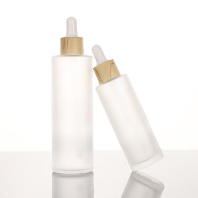 China Low MOQ 100% Cosmetic Biodegradable Brown Skin Care Packaging Bottle Set Bamboo Lid Glass Shampoo Bottle 10-150ml for sale